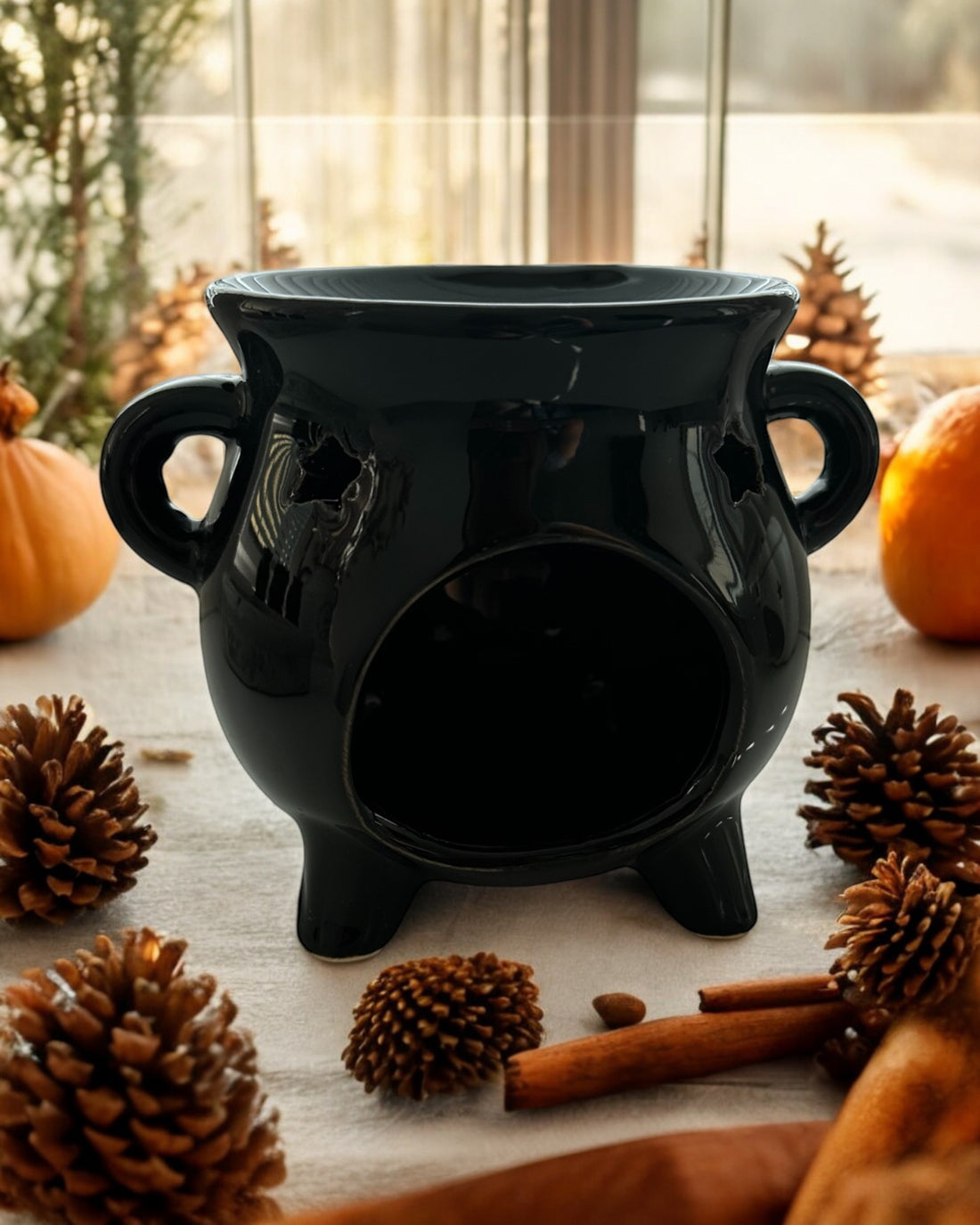 Black Cauldron Wax Melt Burner, featuring a spooky cauldron design perfect for Halloween and autumn décor. Effortlessly fills your home with delightful fragrance by melting your favourite wax melts. Ideal for creating a cosy and magical atmosphere, making it a great gift for wax melt enthusiasts.