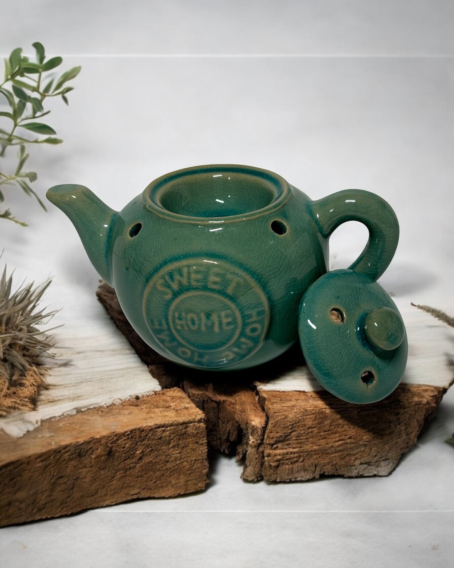 Green ceramic tea pot wax melt burner with lid, perfect for home fragrance and stylish decor.