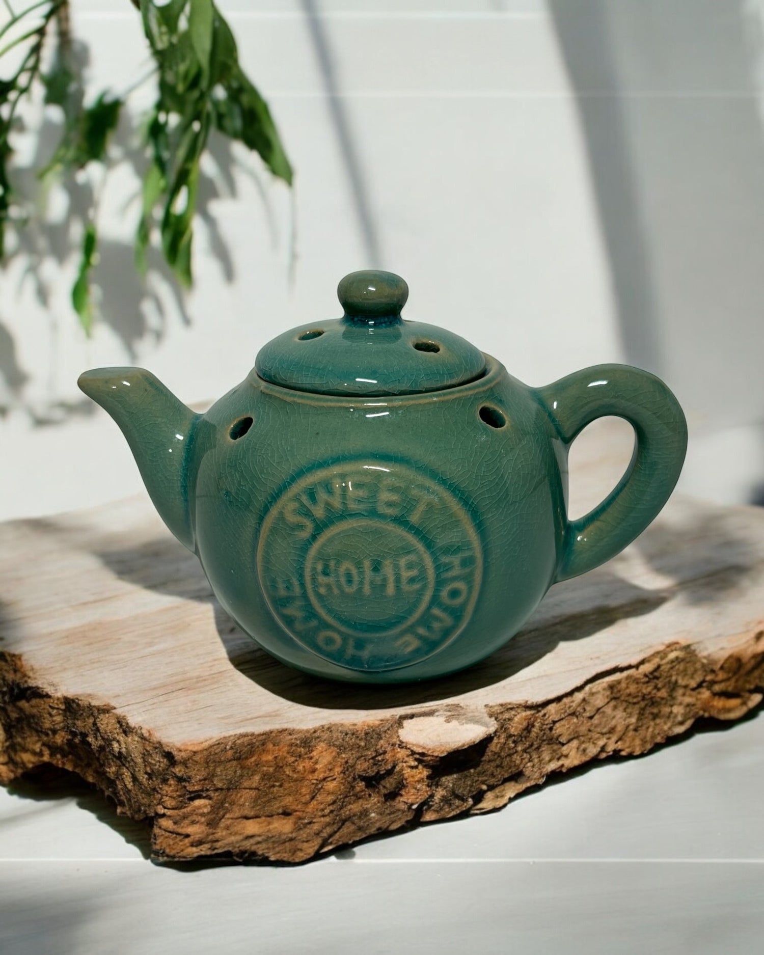 Green ceramic tea pot wax melt burner with lid, perfect for home fragrance and stylish decor.